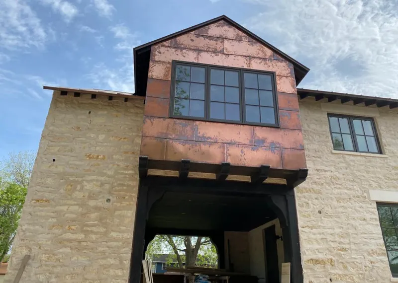 Copper metal panel facade on a stone building for Skylight Installation in Jacksonville